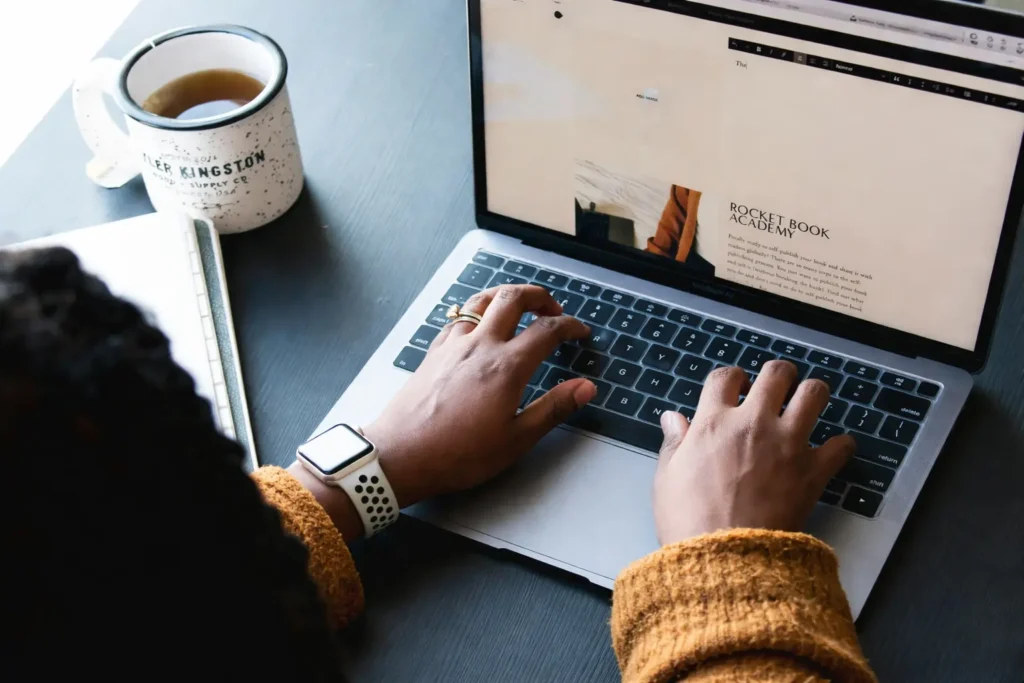 Typing at the desk with tea