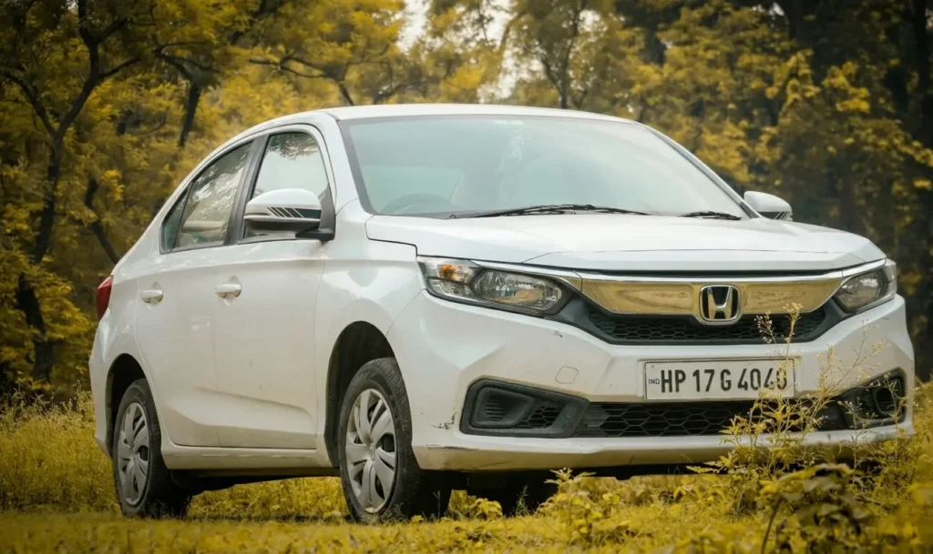 White Honda Civic parked on grass