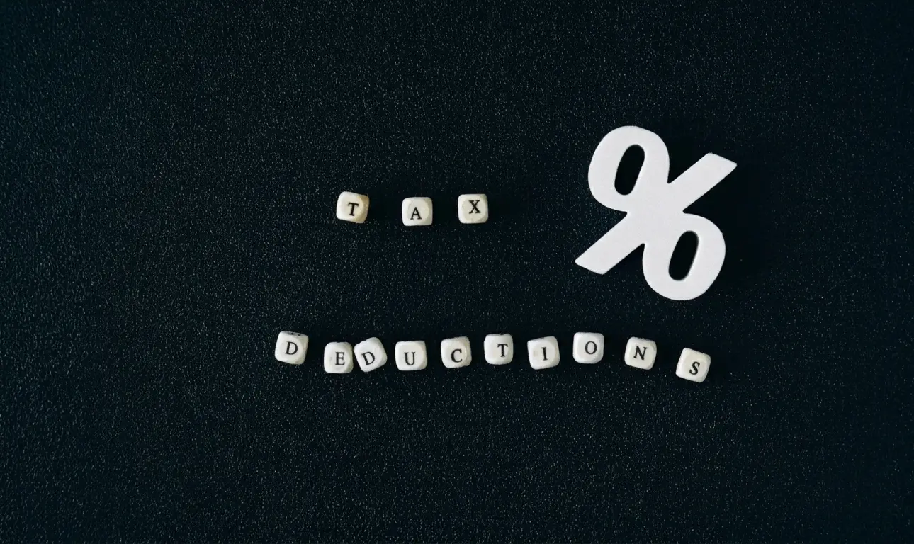 Block tiles representing tax deductions on dark surface