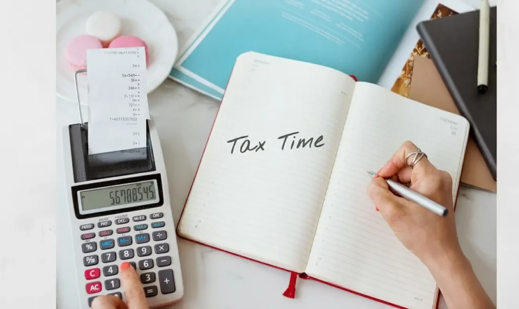 Diary repesenting tax time with calculator on a white table