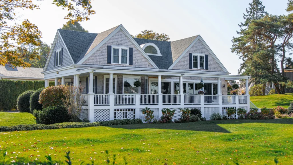 Gray wooden house with a beautiful garden on a sunny day